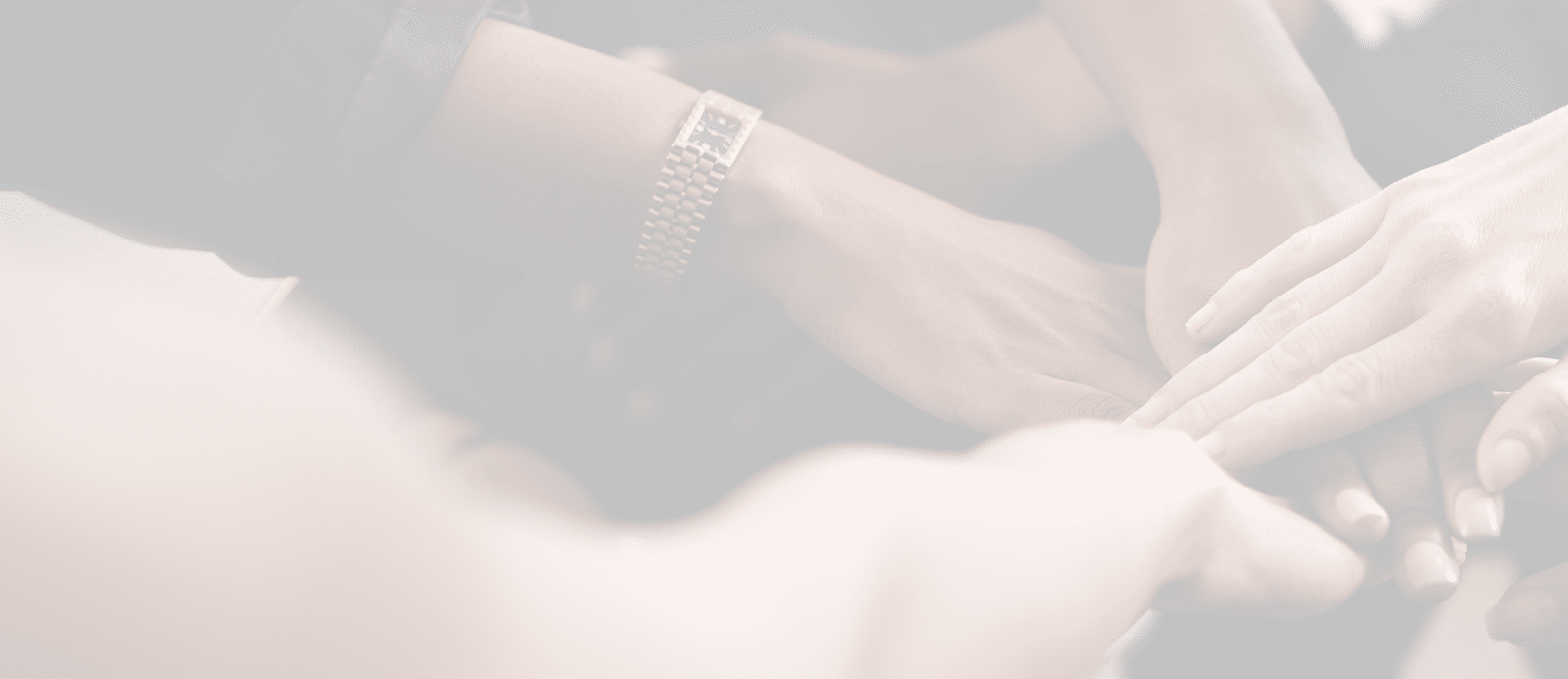 Fashion designers doing a hand stack at a meeting