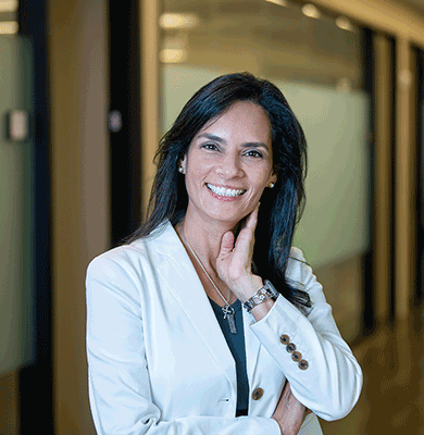 a smiling Latin woman in a white jacket