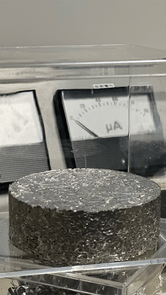 A close-up of a metal puck produced by Sun Metalon.