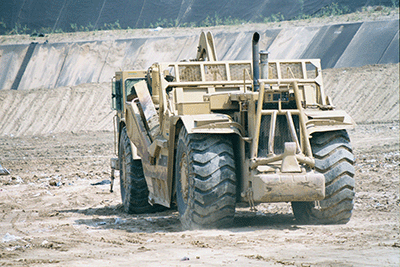 Scraper scraping cover in landfill