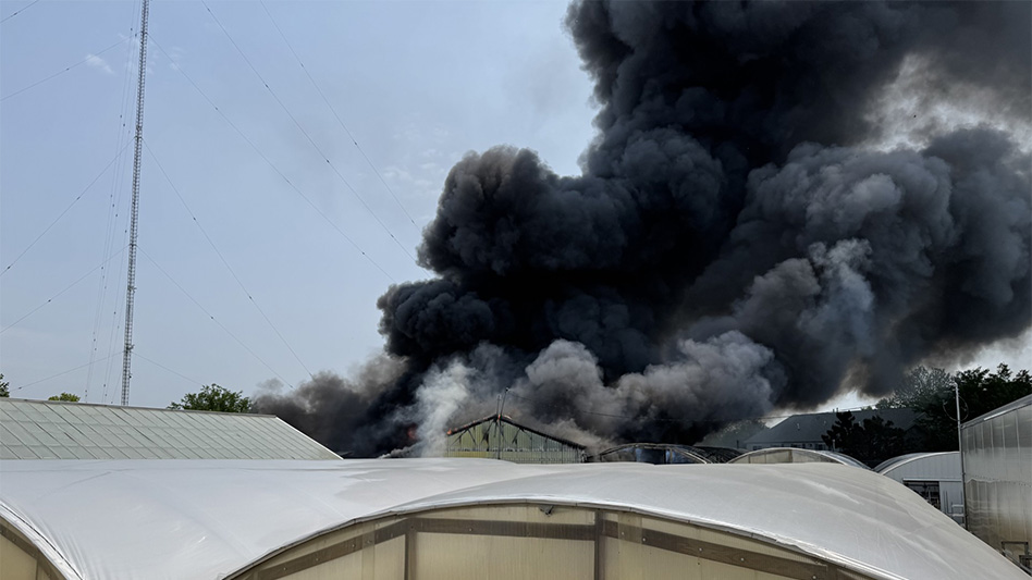 Dark smoke rising out of a greenhouse