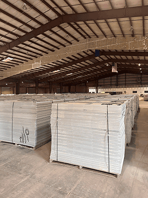 pallets of solar panels in a warehouse