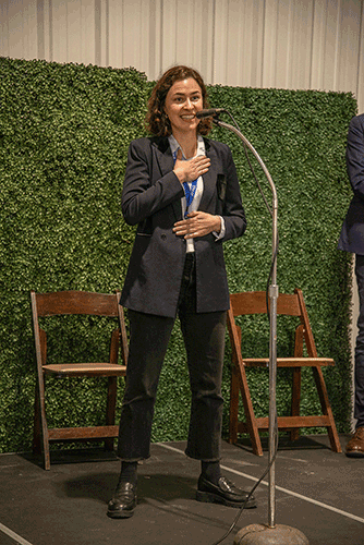 a woman stands on a stage