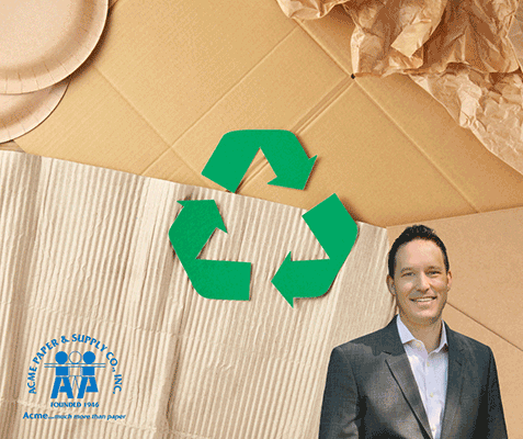 a smiling man in a suit with recylable paper packaging in the background
