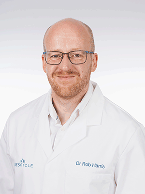 a bald white man with glasses and reddish facial hair