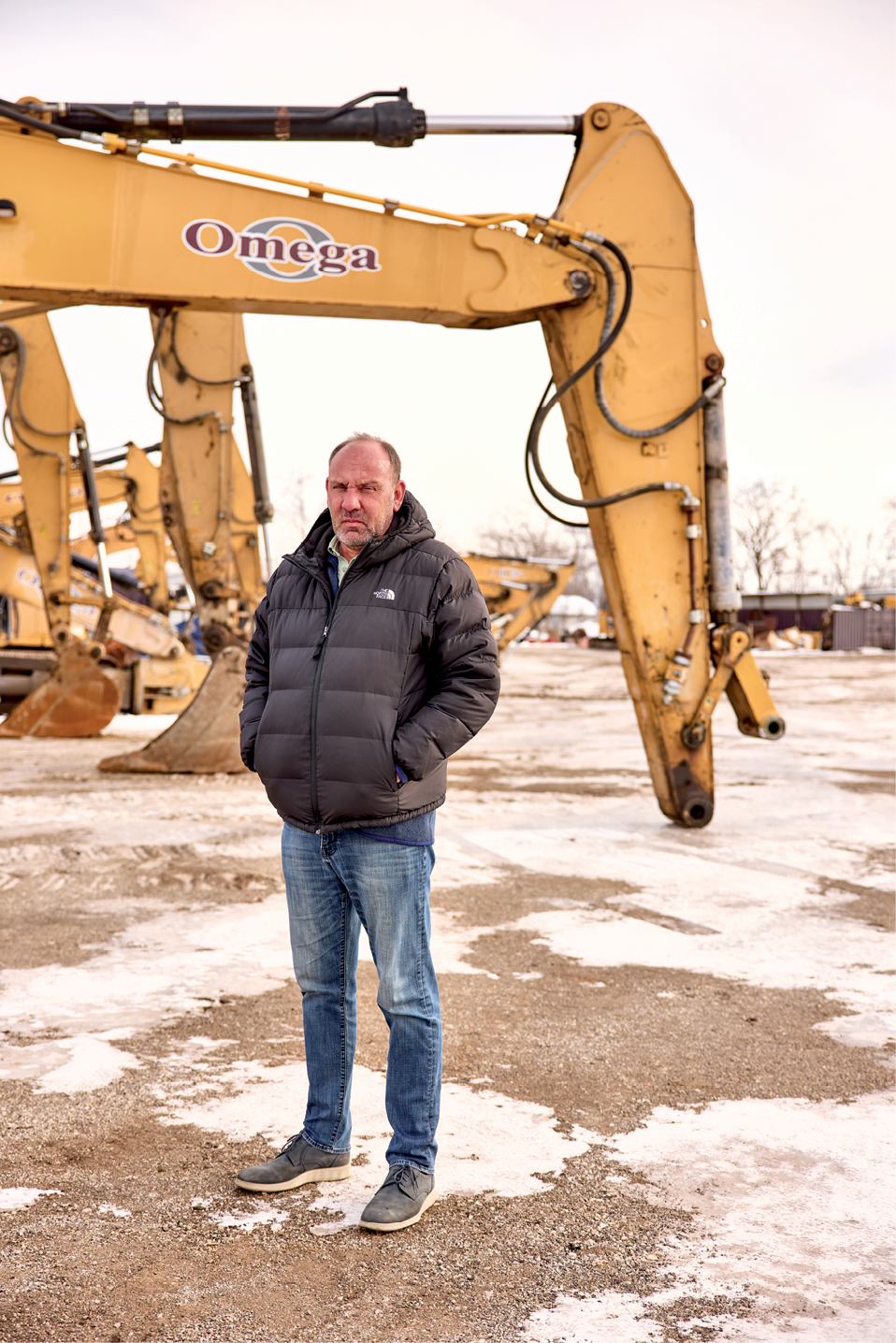man standing in front of heavy equipment
