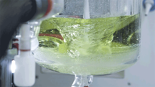 a beaker filled with yellow-ish liquid